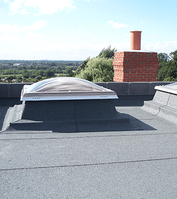 Bailey Classic flat roofing installed on a building around skylights and a chimney